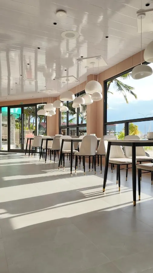 Sunlit breakfast room with sea-facing windows
