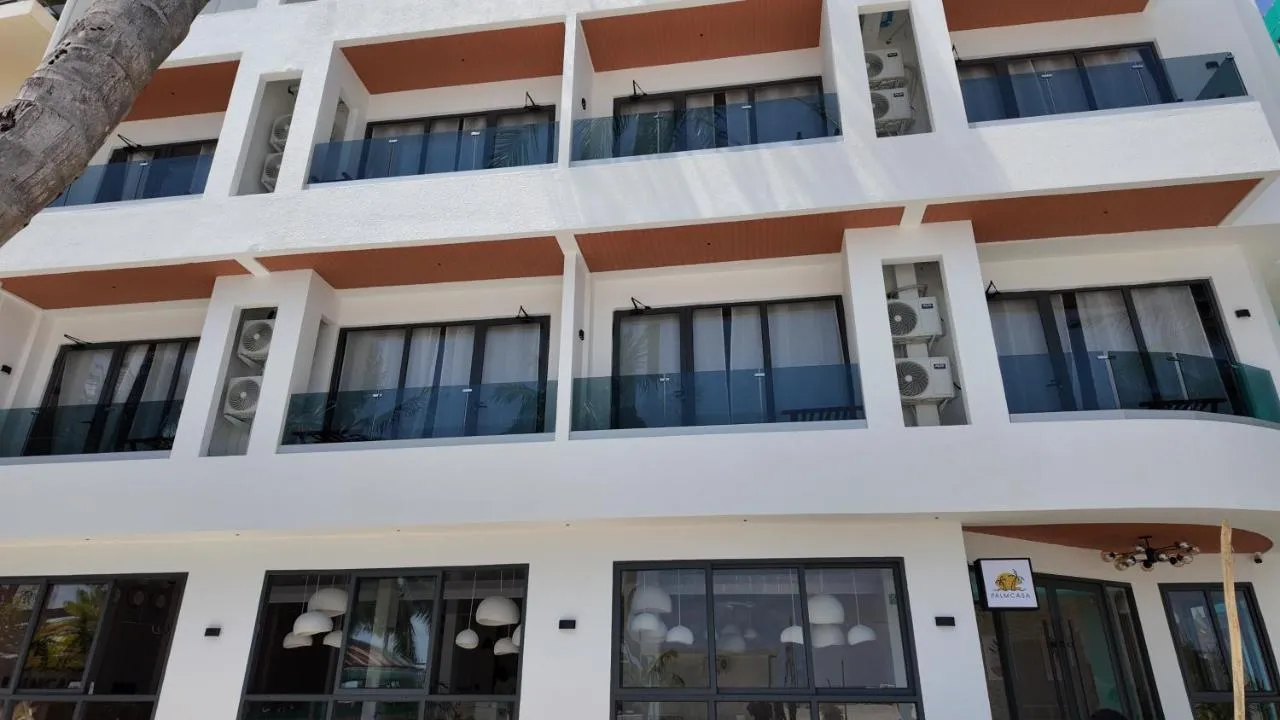 The white Palmcasa building with terracotta soffits and glass balconies