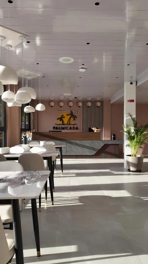 Palmcasa reception with the logo wall and white pendant lights