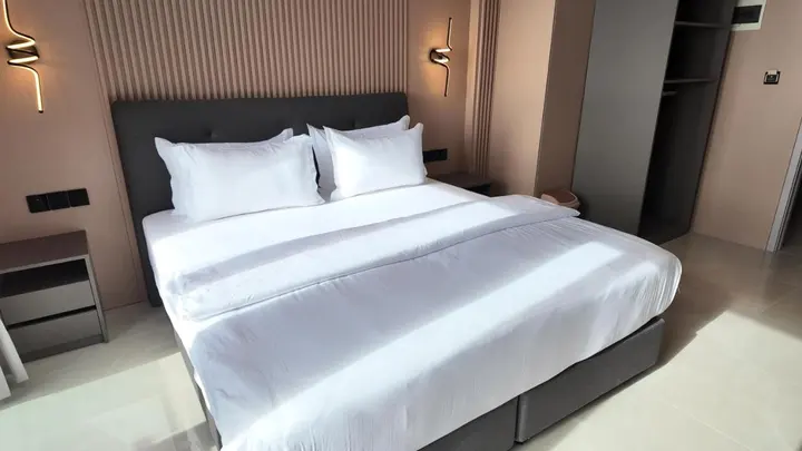 Large double bed with crisp white linen