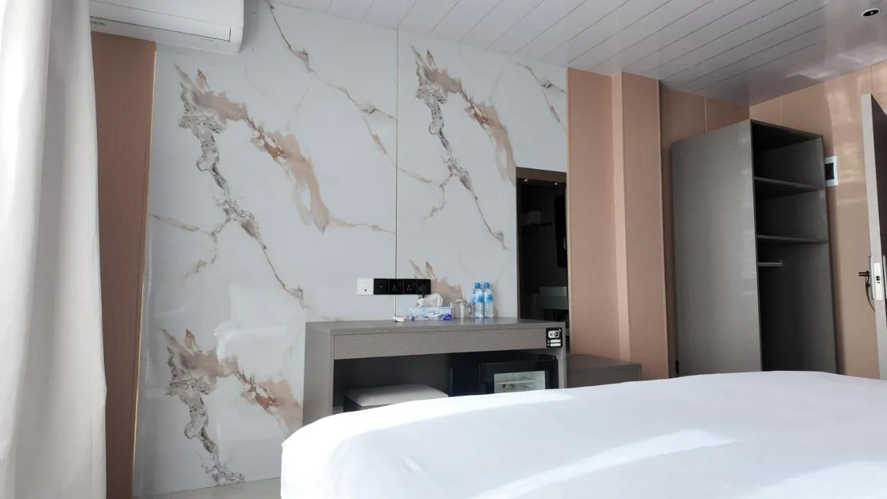 Room with a marble feature wall and vanity desk